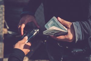 Man buying a gun for money in the street